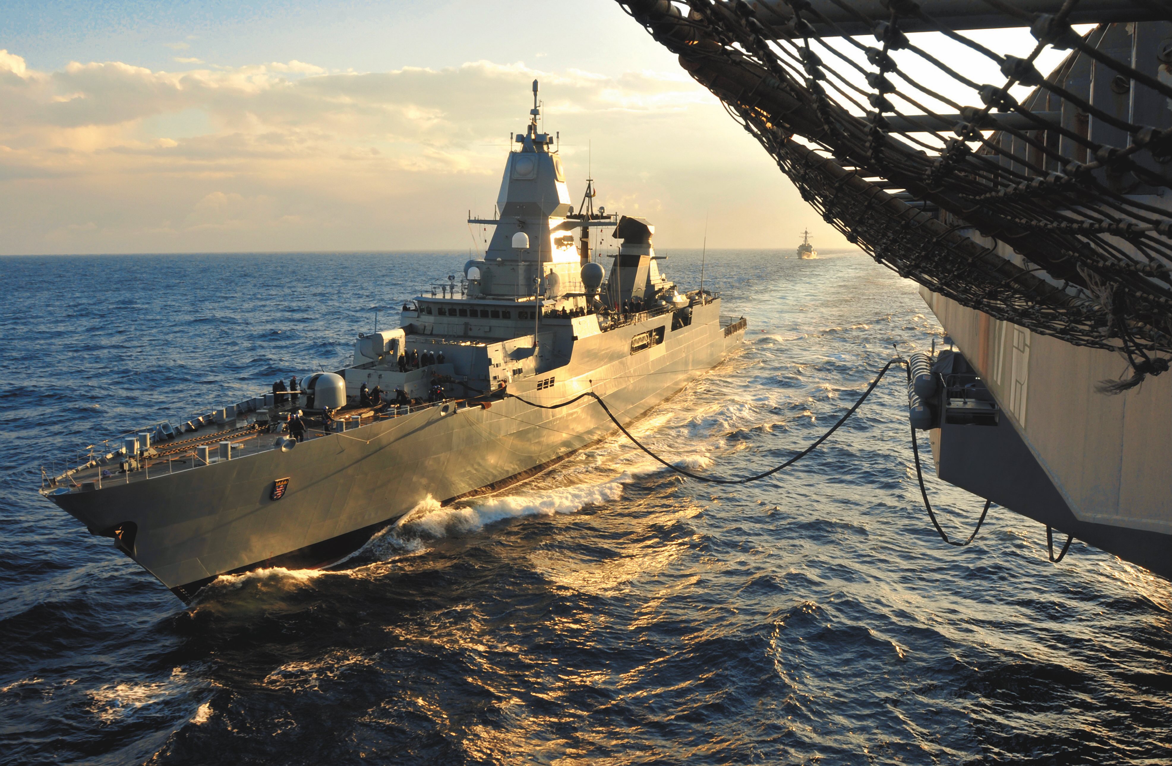 November 5, 2009 - German Sachsen-class frigate Hessen (F221) pulls alongside nuclear aircraft carrier USS Dwight D. Eisenhower (CVN 69) for refueling at sea in the Atlantic Ocean. 
